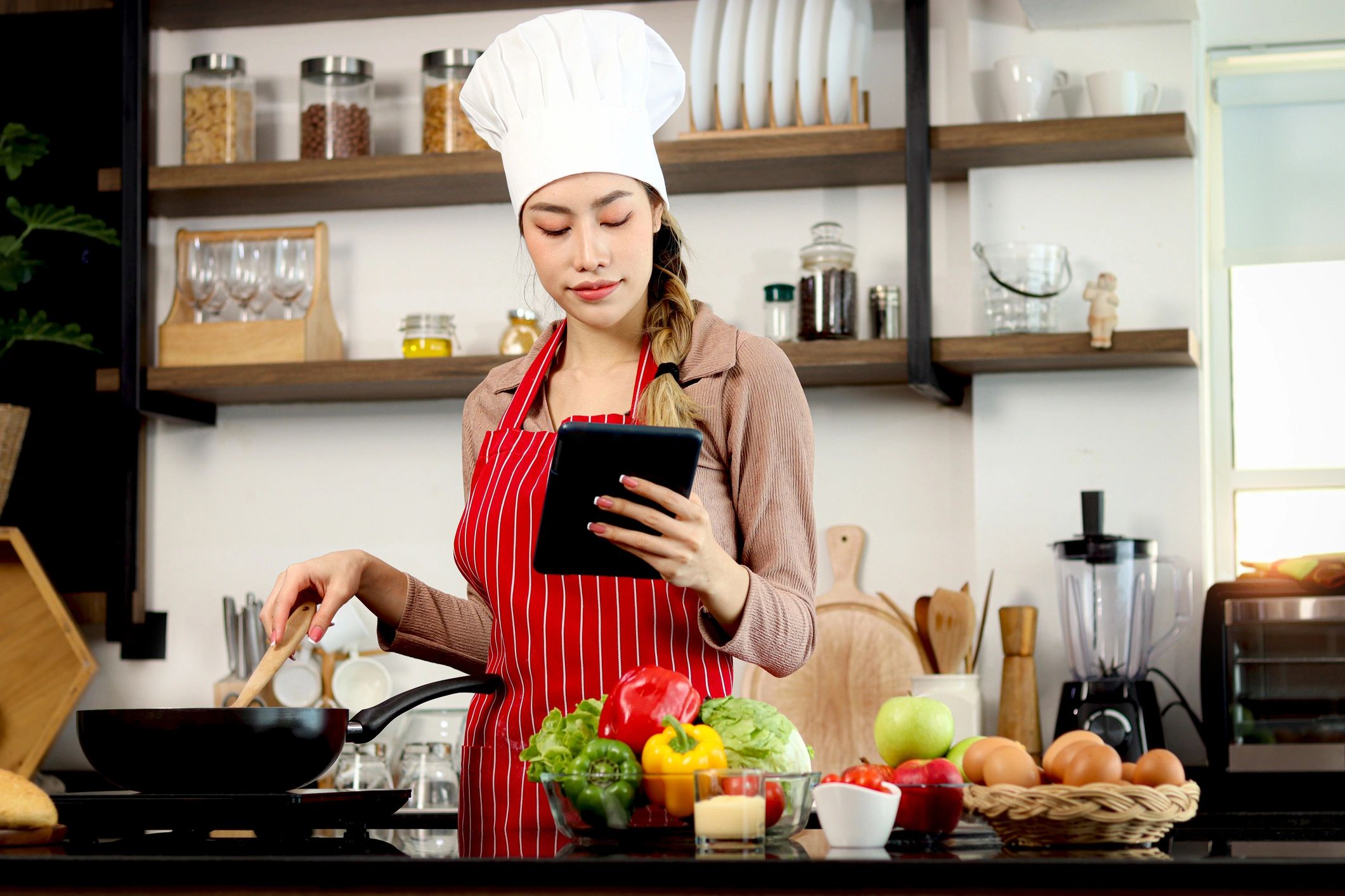 Happy smiling beautiful Asian woman wears apron and.