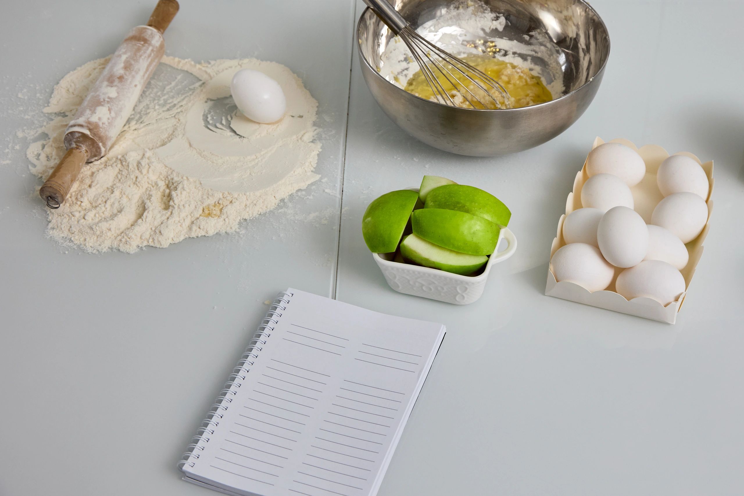 Kneading dough in metal bowl with whisk.